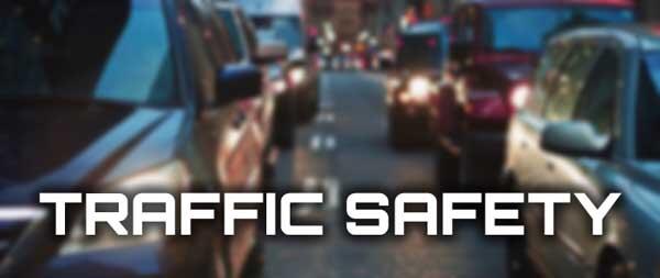 Cars on the road with text stating TRAFFIC SAFETY
