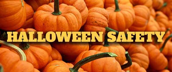Pile of orange pumpkins with stems and caption HALLOWEEN SAFETY