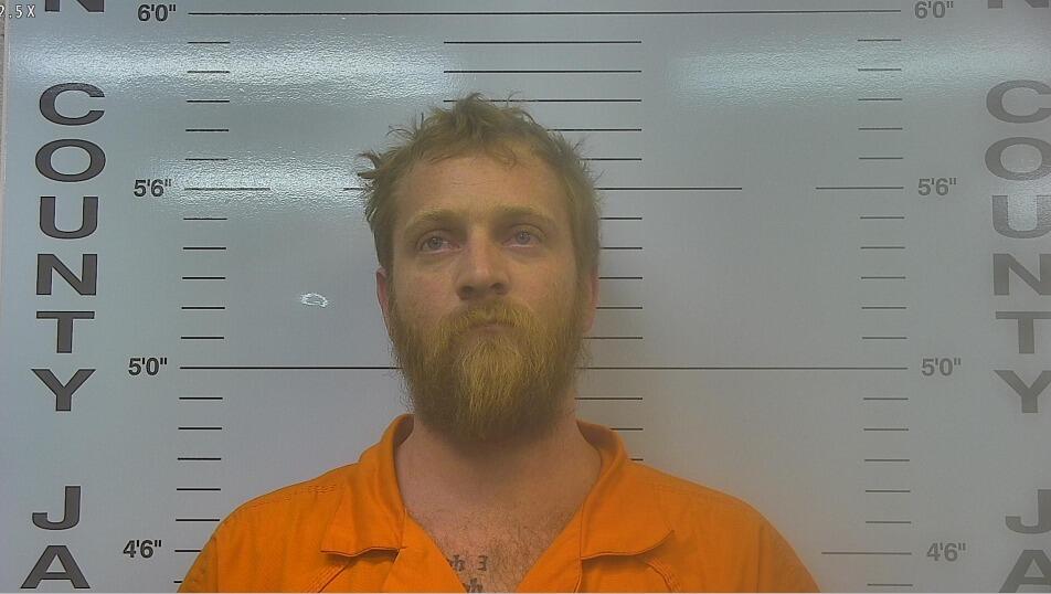 Mugshot of Adam Fritts in orange jumpsuit